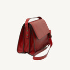 "Full-grain calfskin leather shoulder bag with three compartments, zip closure, rear zip pocket, and adjustable strap"
