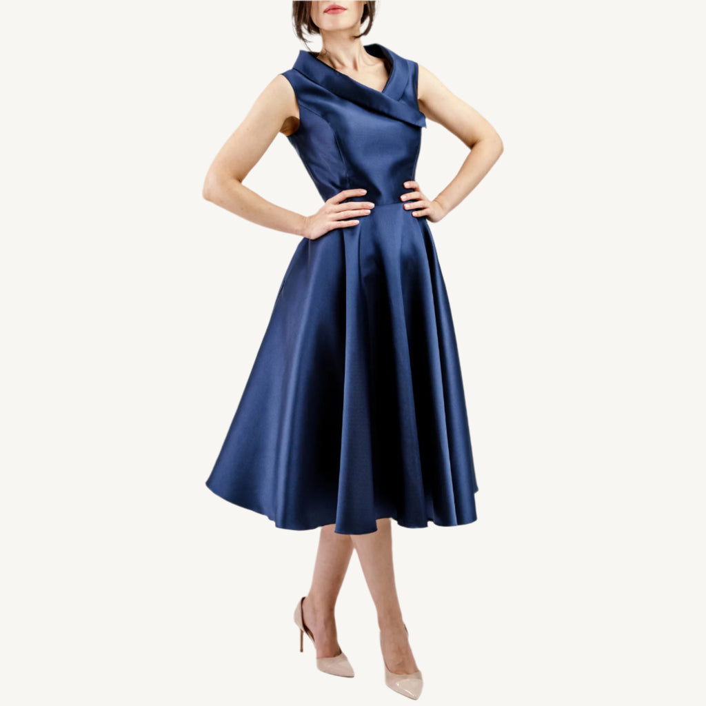 Versatile vintage-inspired dress crafted from pearlescent mikado — lightweight and voluminous with a fitted top, sculpted collar, and a hidden zipper for nursing mothers. Suitable for both daytime and evening events.