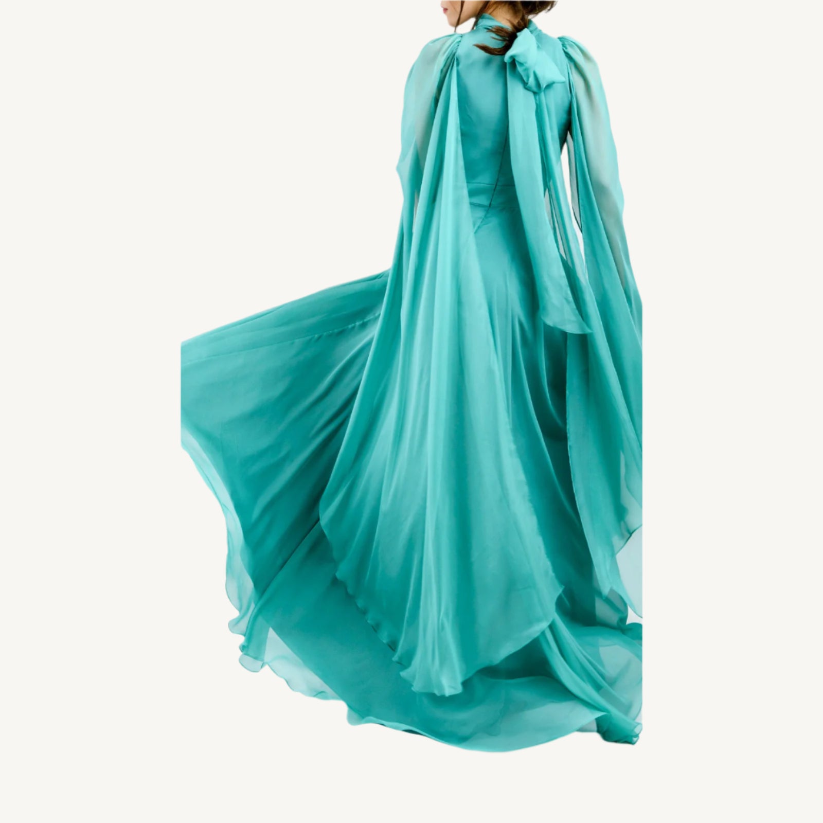 Elegant high-collar gown with long tie-back sides, adjustable sleeves, chiffon and satin layered skirt, built-in V-shaped belt, and invisible back zipper. Made from premium Italian fabrics, fully lined for comfort.