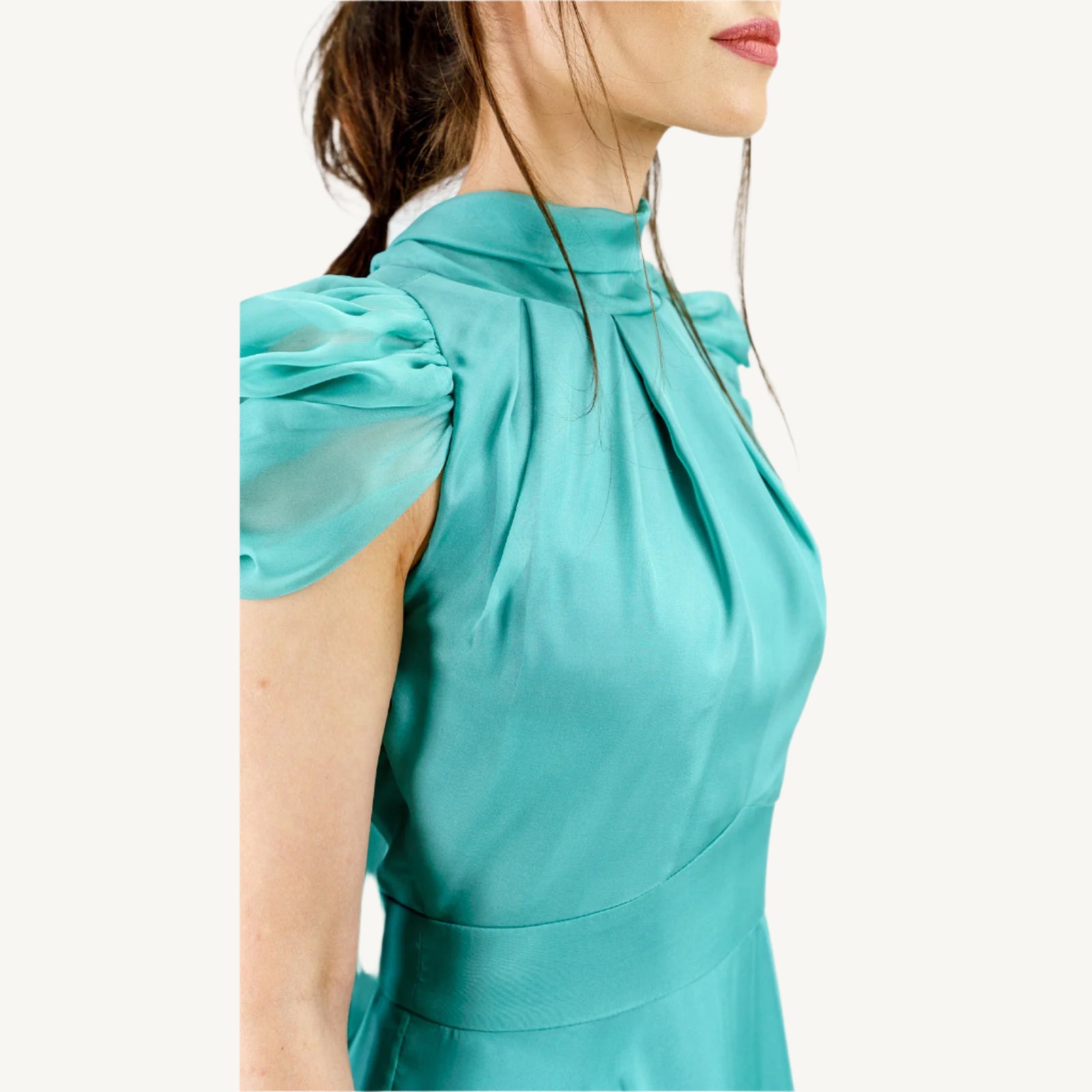 Elegant high-collar gown with long tie-back sides, adjustable sleeves, chiffon and satin layered skirt, built-in V-shaped belt, and invisible back zipper. Made from premium Italian fabrics, fully lined for comfort.