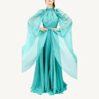 Elegant high-collar gown with long tie-back sides, adjustable sleeves, chiffon and satin layered skirt, built-in V-shaped belt, and invisible back zipper. Made from premium Italian fabrics, fully lined for comfort.