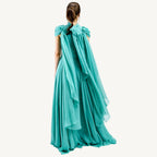 Elegant high-collar gown with long tie-back sides, adjustable sleeves, chiffon and satin layered skirt, built-in V-shaped belt, and invisible back zipper. Made from premium Italian fabrics, fully lined for comfort.
