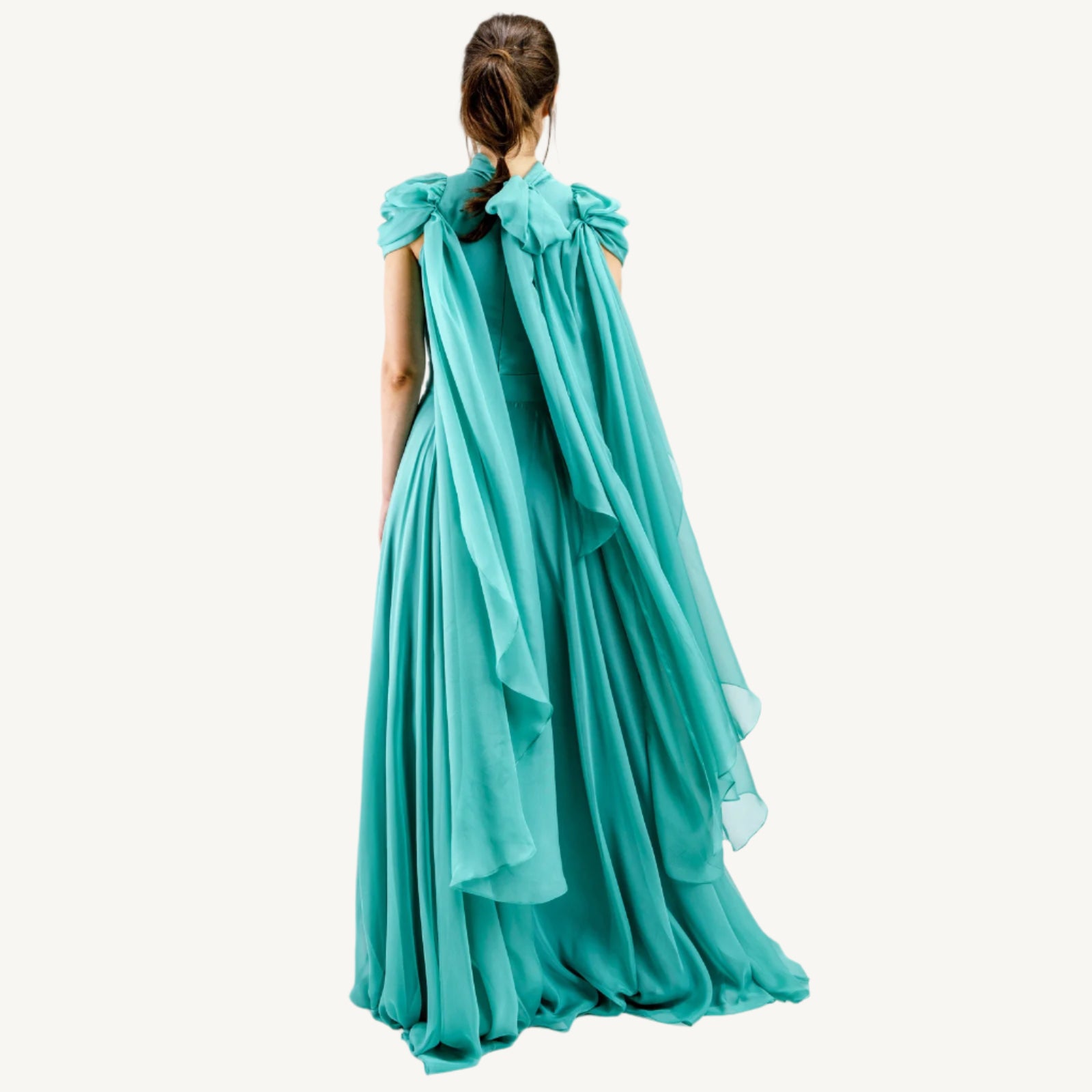 Elegant high-collar gown with long tie-back sides, adjustable sleeves, chiffon and satin layered skirt, built-in V-shaped belt, and invisible back zipper. Made from premium Italian fabrics, fully lined for comfort.
