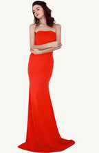 Elegant woman wearing the Evelyn Belluci Red Strapless Gown, featuring a sculpted neckline and flowing maxi silhouette, perfect for glamorous evening occasions.